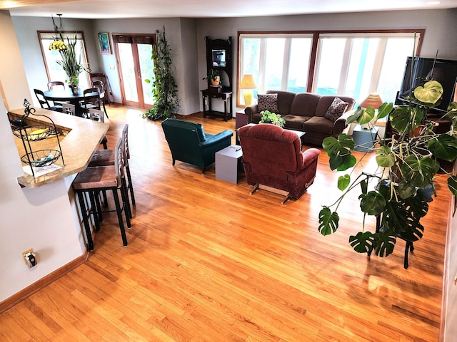 living area with light wood-style flooring and baseboards