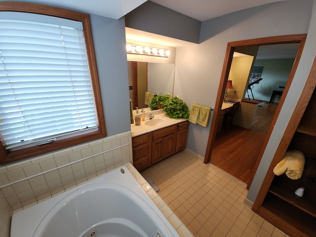 full bathroom featuring vanity, a whirlpool tub, and tile patterned floors
