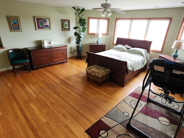 bedroom featuring light wood-type flooring and a ceiling fan