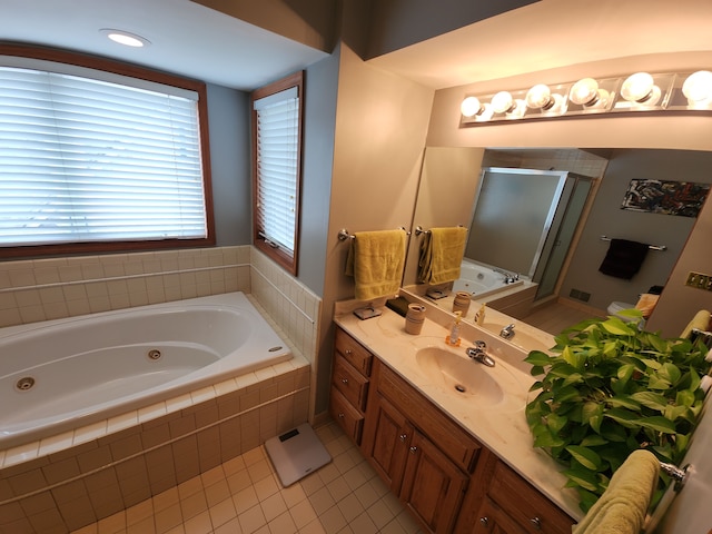 full bath with a stall shower, vanity, a tub with jets, and tile patterned floors