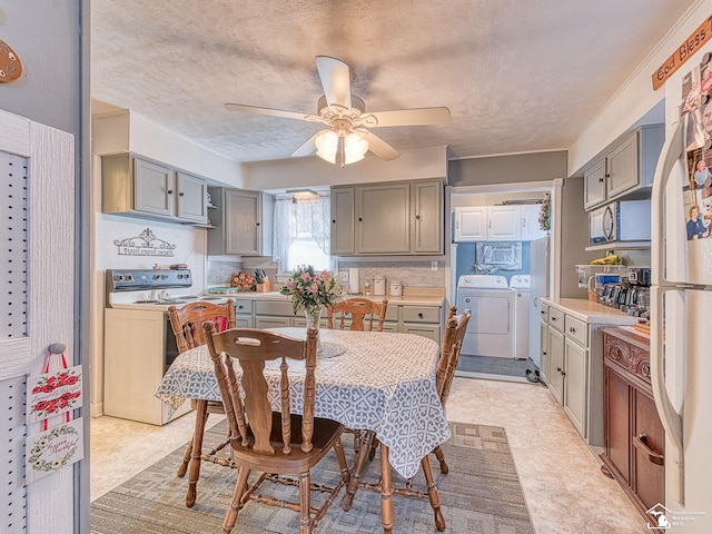 dining area with a textured ceiling, washing machine and dryer, and a ceiling fan