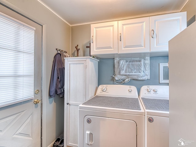 clothes washing area featuring cabinet space and separate washer and dryer