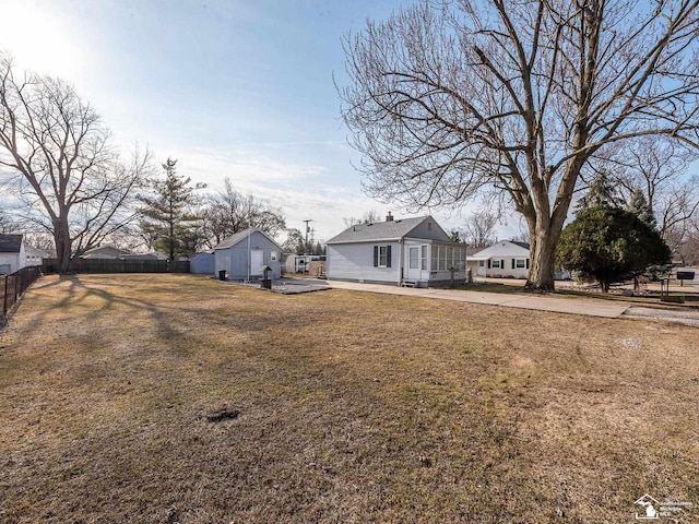 view of yard featuring an outbuilding and fence