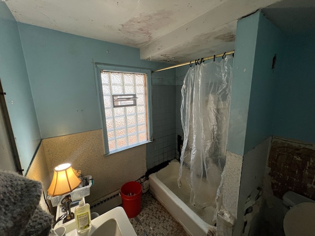 bathroom with toilet, shower / tub combo with curtain, and a baseboard radiator