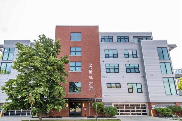 100 N Center St Unit 302, Royal Oak, MI 48067 - view of building exterior featuring a garage and driveway
