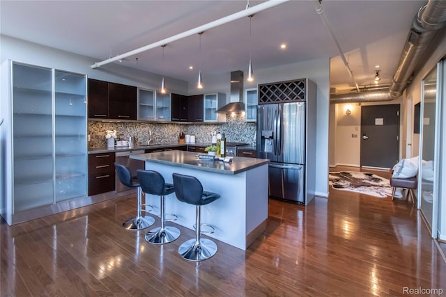 100 N Center St Unit 302, Royal Oak, MI 48067 - kitchen featuring stainless steel appliances, wall chimney range hood, modern cabinets, dark countertops, and dark wood-type flooring