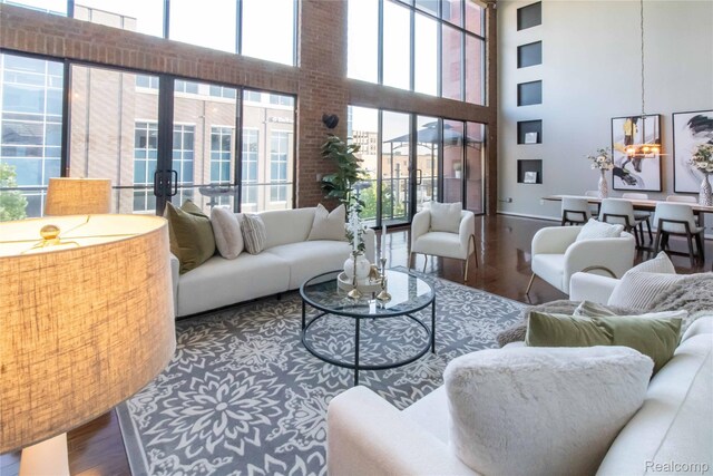 100 N Center St Unit 302, Royal Oak, MI 48067 - living area featuring a towering ceiling, wood finished floors, and french doors