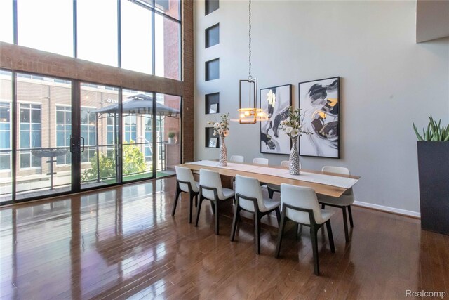 100 N Center St Unit 302, Royal Oak, MI 48067 - dining space featuring a towering ceiling and wood finished floors