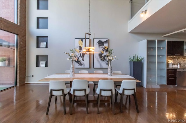 100 N Center St Unit 302, Royal Oak, MI 48067 - dining space featuring a towering ceiling and dark wood-style flooring