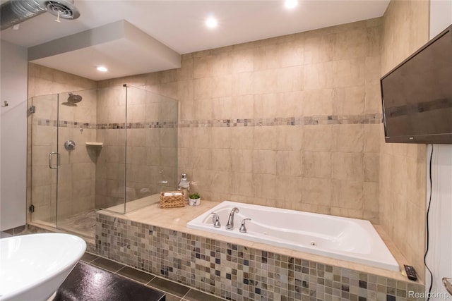 100 N Center St Unit 302, Royal Oak, MI 48067 - full bathroom with a tub with jets, a shower stall, tile walls, tile patterned flooring, and recessed lighting
