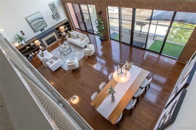100 N Center St Unit 302, Royal Oak, MI 48067 - living area featuring wood finished floors, a glass covered fireplace, and expansive windows