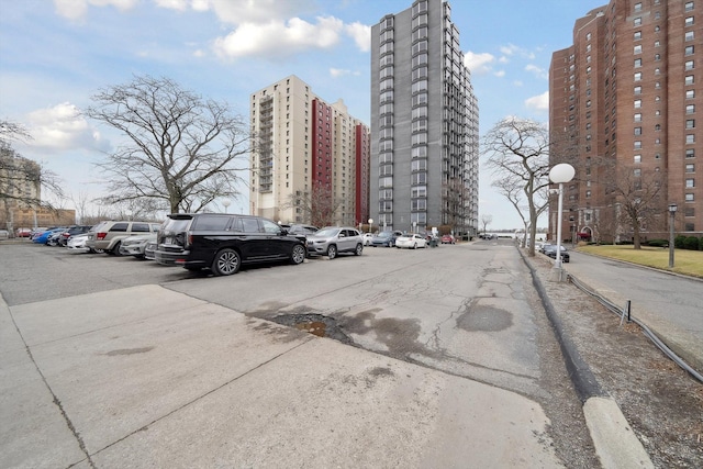 view of property with a view of city and uncovered parking