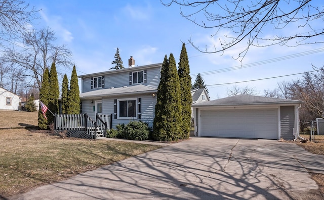 view of front of house with an outbuilding, a front lawn, a chimney, and a garage