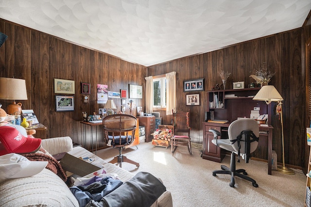 carpeted office space featuring wooden walls