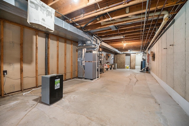 unfinished basement featuring heating unit