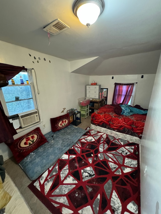 carpeted bedroom featuring visible vents, cooling unit, and lofted ceiling