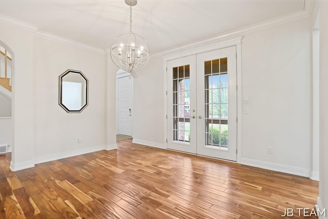 6579 Partridge Ln, Holland, MI 49423 - unfurnished dining area featuring french doors, ornamental molding, light wood-type flooring, a chandelier, and baseboards