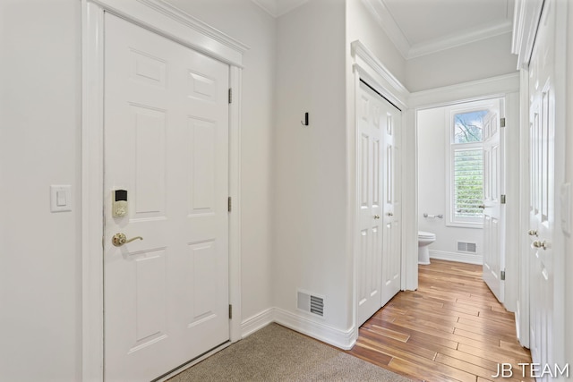 6579 Partridge Ln, Holland, MI 49423 - foyer with baseboards, ornamental molding, and light wood-type flooring