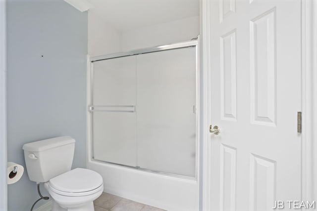 6579 Partridge Ln, Holland, MI 49423 - bathroom featuring tile patterned flooring, toilet, and bath / shower combo with glass door