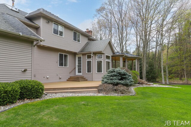 6579 Partridge Ln, Holland, MI 49423 - back of property featuring a yard and a chimney