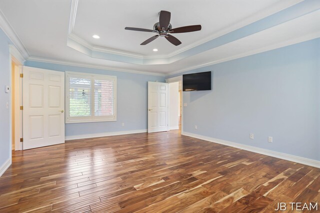 6579 Partridge Ln, Holland, MI 49423 - spare room with a raised ceiling, wood finished floors, ornamental molding, a ceiling fan, and baseboards