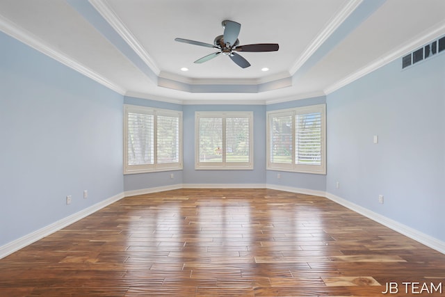 6579 Partridge Ln, Holland, MI 49423 - spare room featuring a raised ceiling, dark wood finished floors, a ceiling fan, ornamental molding, and baseboards