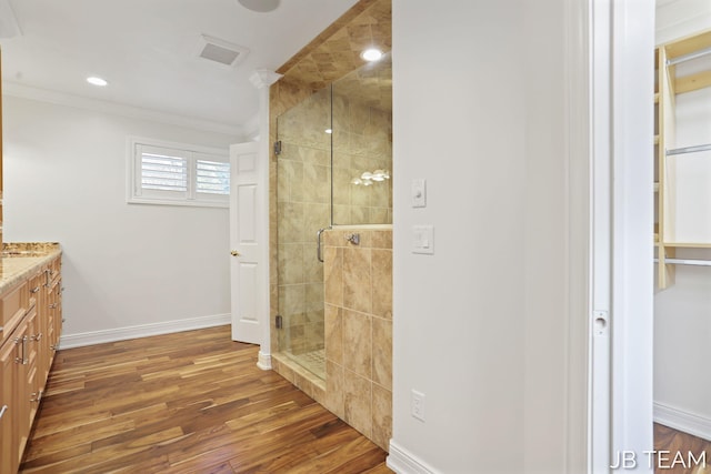 6579 Partridge Ln, Holland, MI 49423 - bathroom with a shower stall, ornamental molding, vanity, wood finished floors, and baseboards