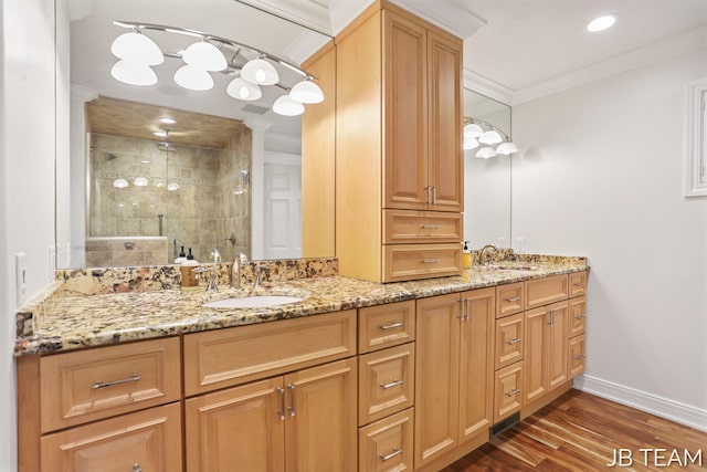 6579 Partridge Ln, Holland, MI 49423 - bathroom featuring a shower stall, wood finished floors, ornamental molding, double vanity, and ornate columns