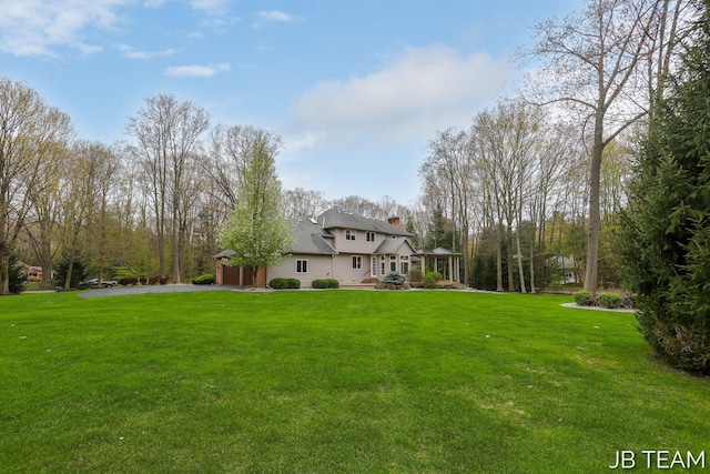 6579 Partridge Ln, Holland, MI 49423 - view of grassy yard with driveway and a garage
