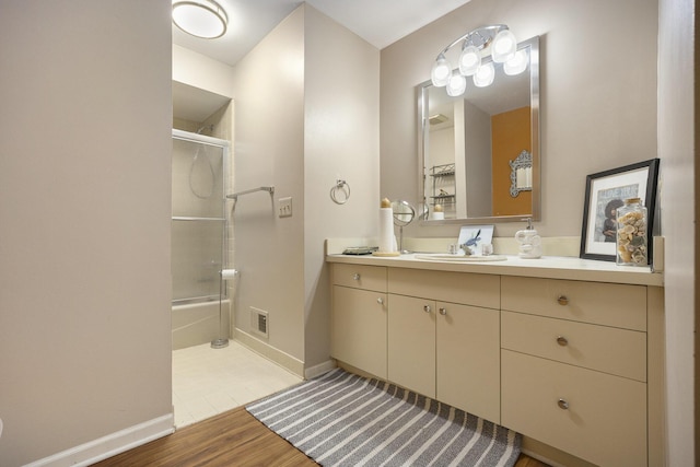 23930 Greenglen Ct, Franklin, MI 48025 - bathroom with baseboards, bath / shower combo with glass door, wood finished floors, and vanity