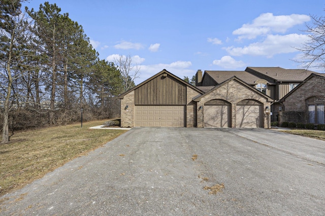 23930 Greenglen Ct, Franklin, MI 48025 - view of front of property with board and batten siding, an attached garage, brick siding, and driveway