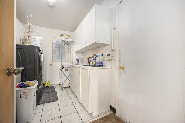 23930 Greenglen Ct, Franklin, MI 48025 - laundry area featuring light tile patterned floors, cabinet space, and washer / dryer