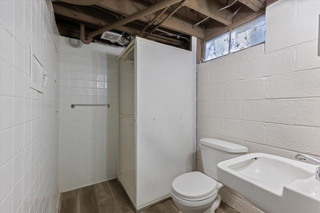 bathroom with toilet and wood finished floors