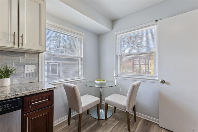 dining area featuring wood finished floors and baseboards