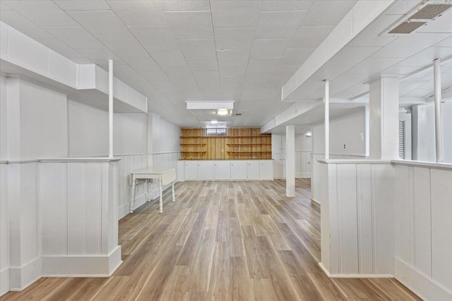 finished basement featuring light wood-style flooring