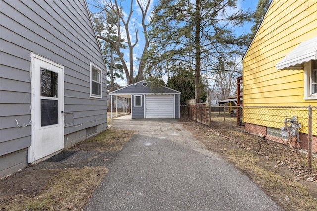 detached garage with fence and driveway