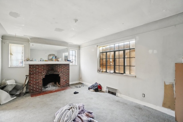 living room featuring baseboards, carpet, and a brick fireplace