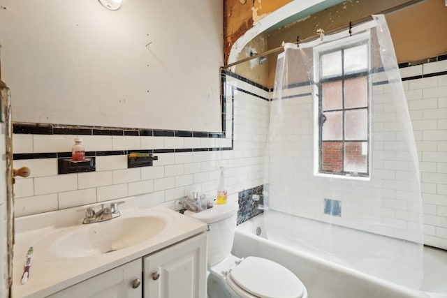 full bathroom with vanity, tile walls, toilet, and shower / bathing tub combination