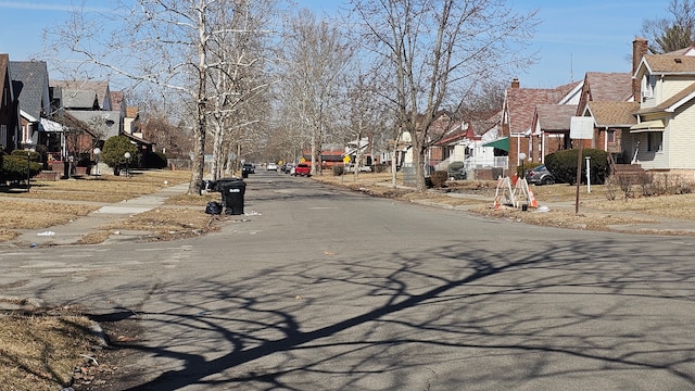 view of road with sidewalks, curbs, and a residential view