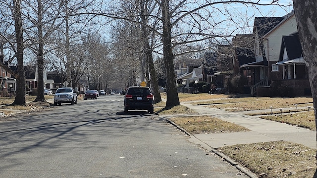 view of road featuring a residential view, curbs, and sidewalks