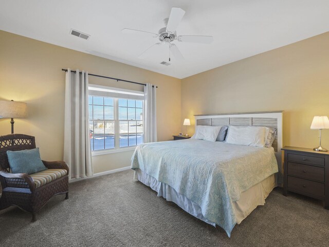 bedroom featuring baseboards, visible vents, a ceiling fan, and carpet