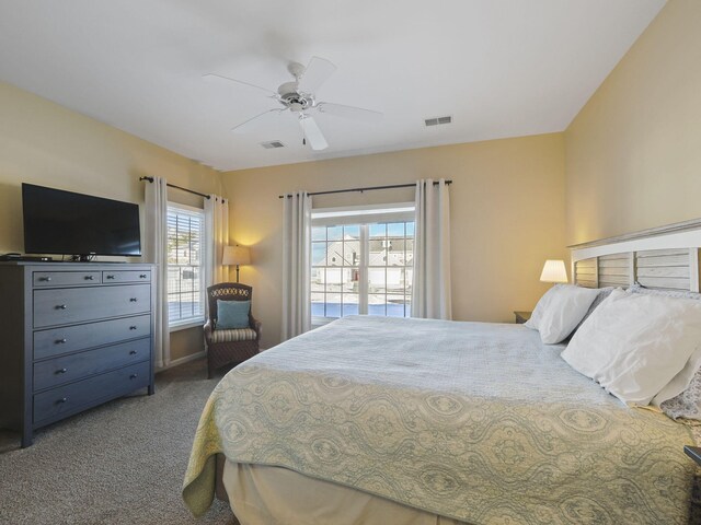 bedroom featuring carpet flooring, a ceiling fan, and visible vents