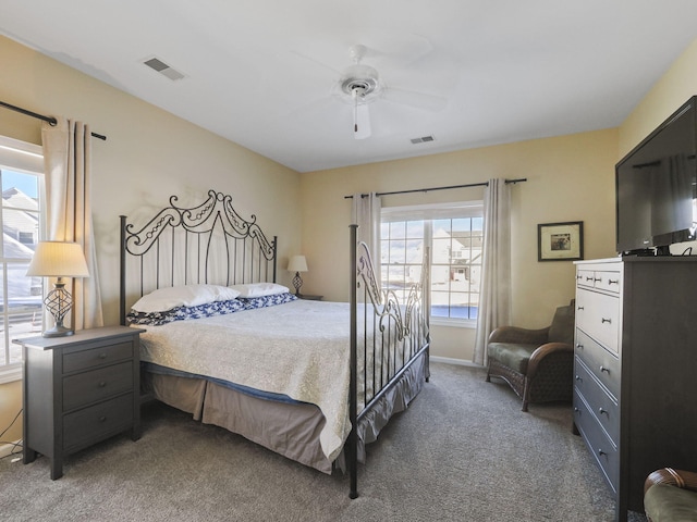 carpeted bedroom featuring visible vents and a ceiling fan