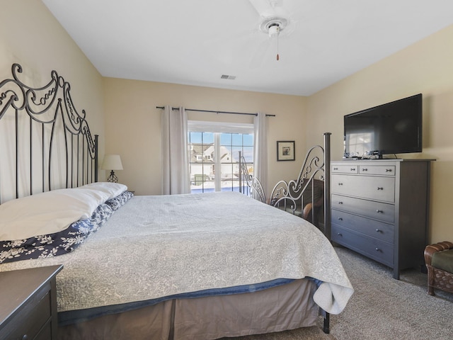 bedroom featuring visible vents, a ceiling fan, and carpet