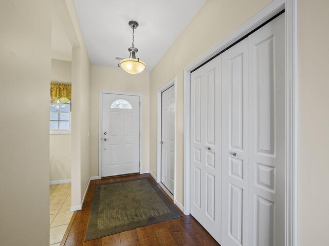 entryway featuring baseboards and wood finished floors
