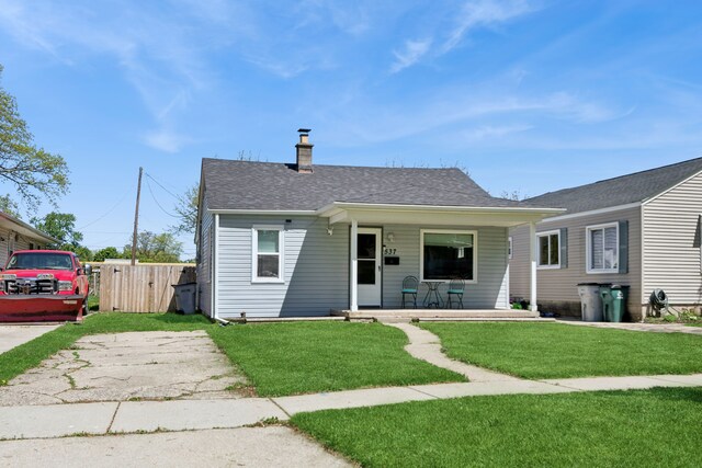 537 Andresen Ct, Hazel Park, MI 48030 - bungalow featuring covered porch, a chimney, and roof with shingles