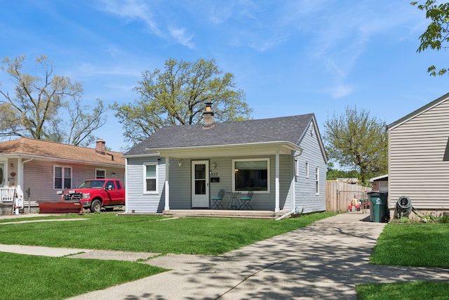 537 Andresen Ct, Hazel Park, MI 48030 - view of front of home featuring covered porch, a front lawn, a chimney, and concrete driveway