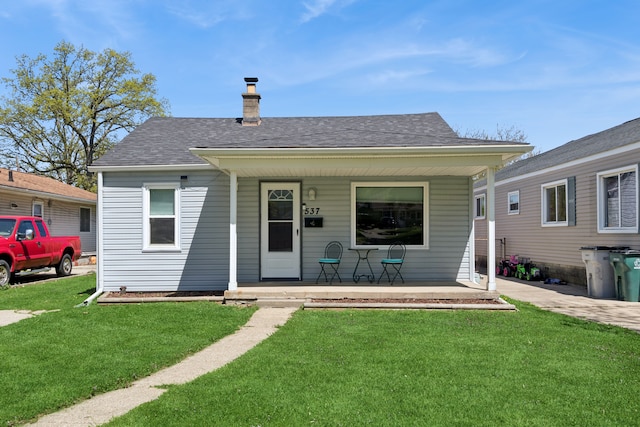537 Andresen Ct, Hazel Park, MI 48030 - bungalow-style home with a porch, a front lawn, a chimney, and a shingled roof