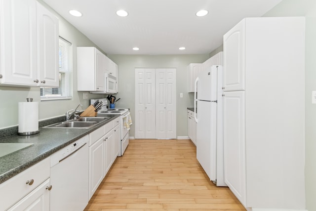 537 Andresen Ct, Hazel Park, MI 48030 - kitchen with white appliances, a sink, light wood finished floors, dark countertops, and white cabinets