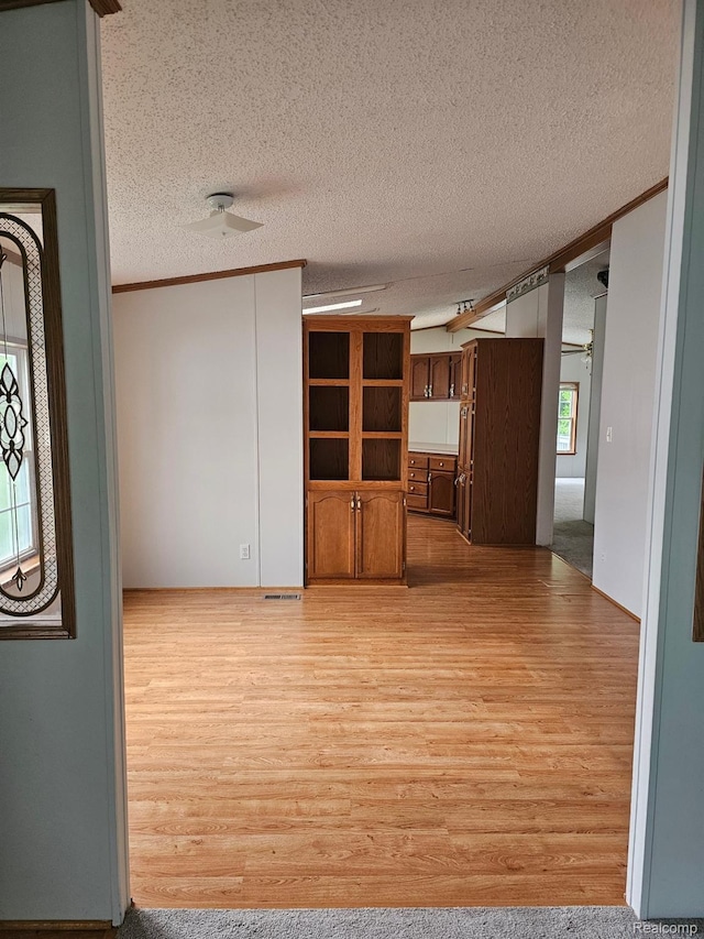 73 Grey Fox Ct, Grand Blanc, MI 48439 - unfurnished living room with crown molding, light wood-style floors, and a textured ceiling